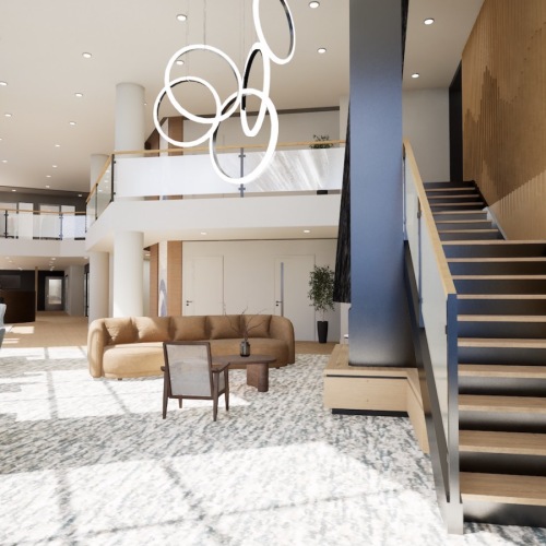 a lounge with a couch, tables, chairs and stairs